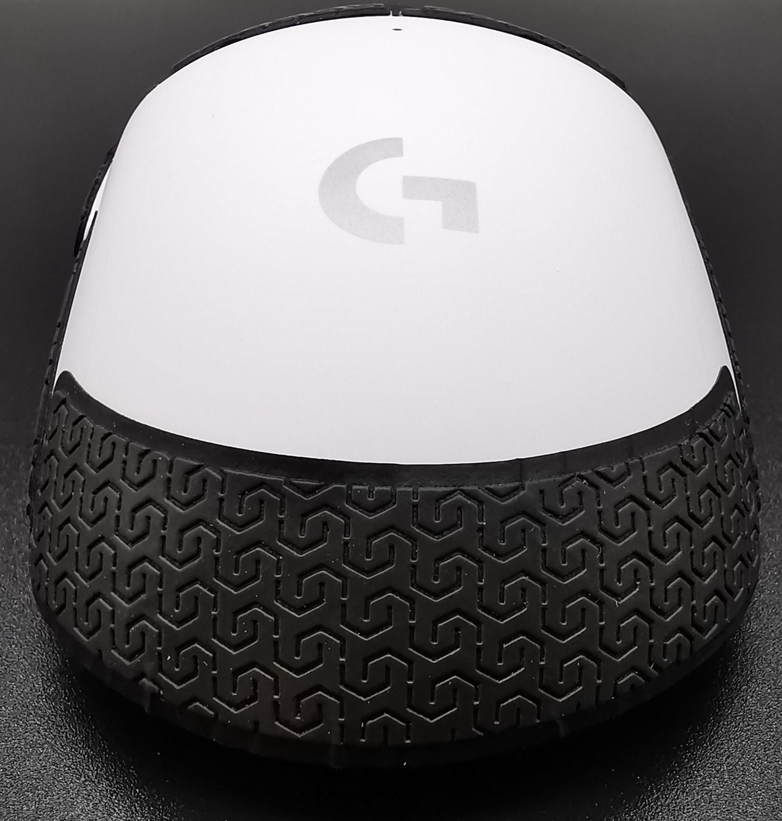 Image of a white Logitech G PRO X SUPERLIGHT with Corepad Soft Grips installed. The mouse is facing away from the camera.