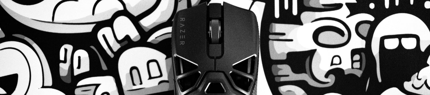 Razer Viper Mini Signature Edition sitting on LA ONDA X NACHOCUSTOMZ RIZZ 'DOODLES' mouse pad. The image is in black and white, the background is cartoonish and the focus of the image is the gaming mouse. 